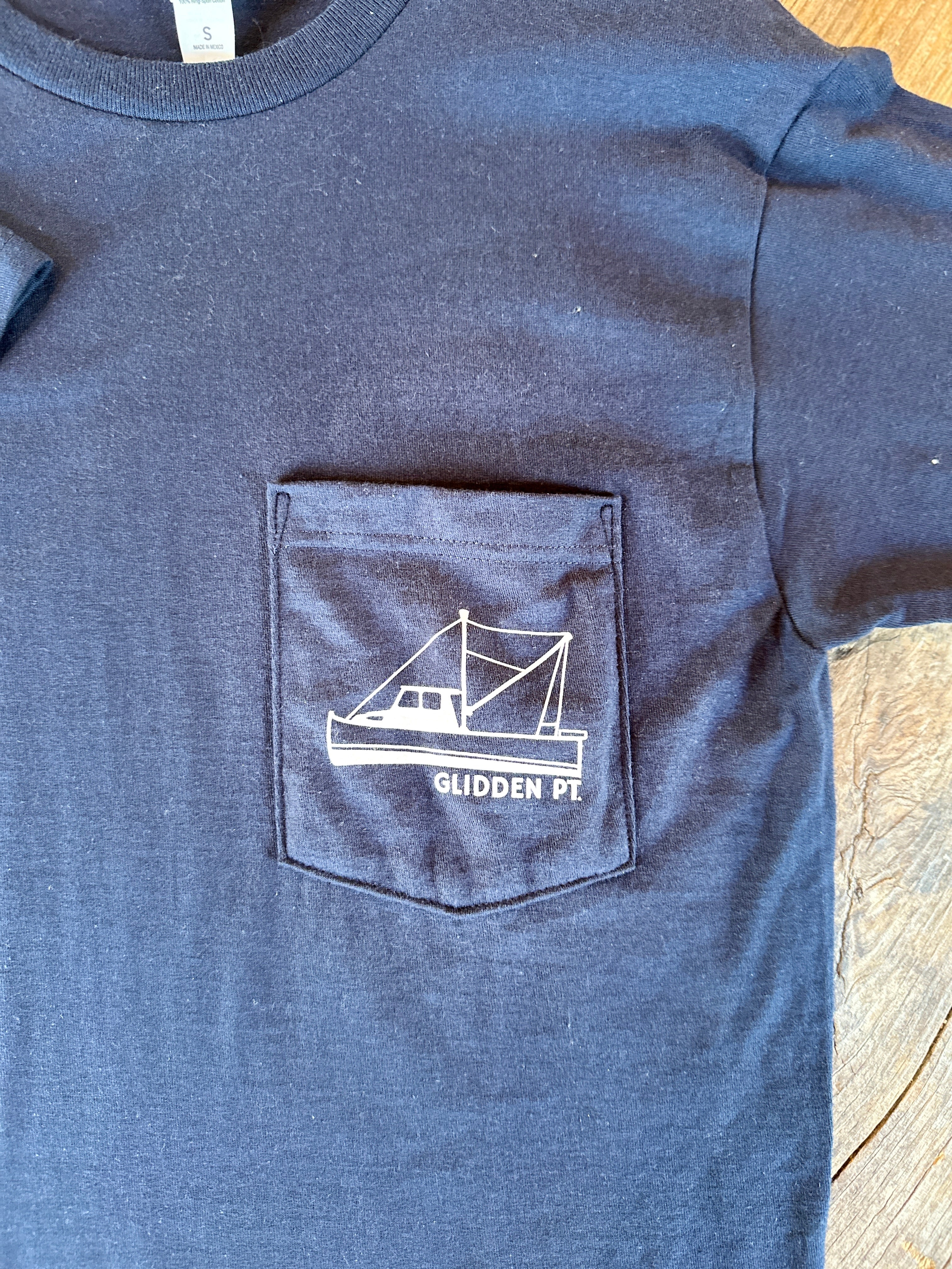 Blue t-shirt with a white logo on a wooden surface