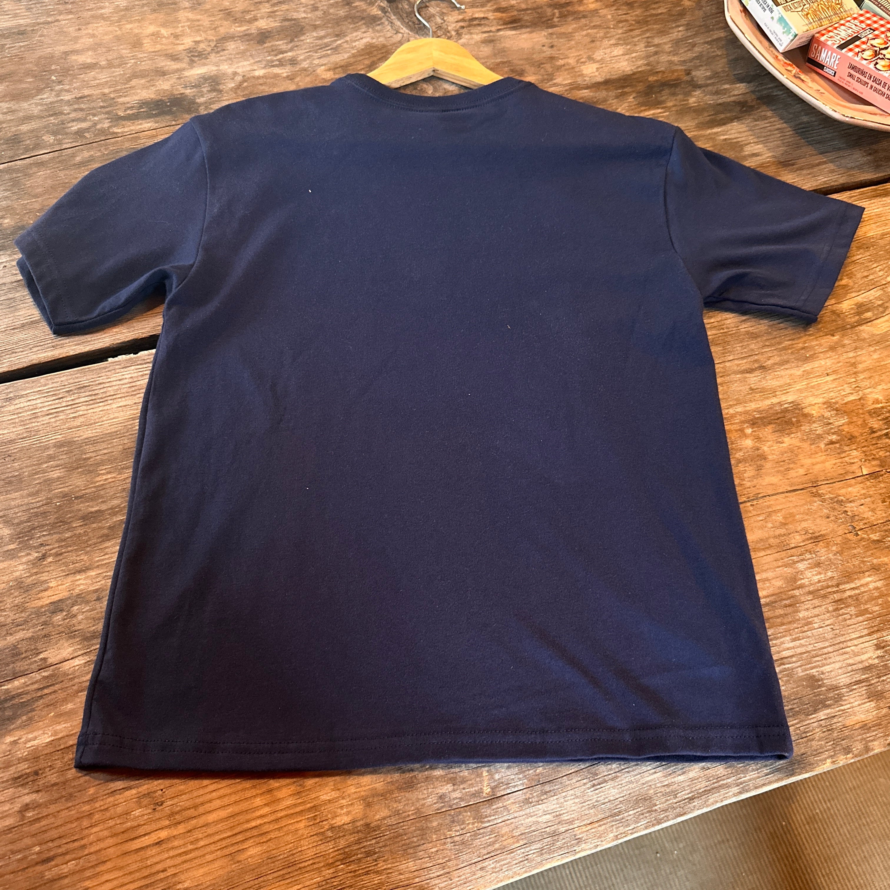 Navy blue t-shirt on a wooden surface